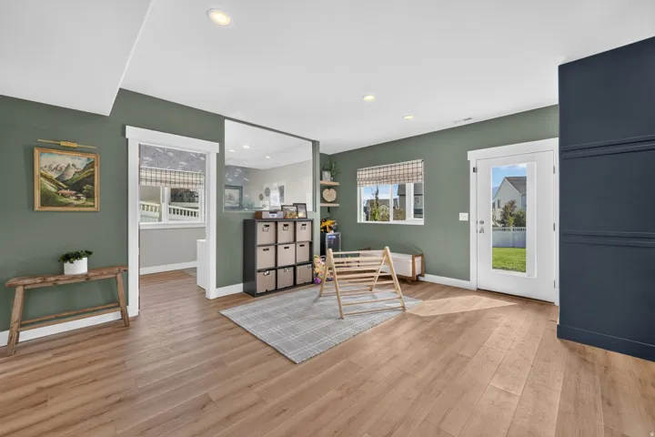Wood-finish flooring, recessed lighting, and a full-light exterior door