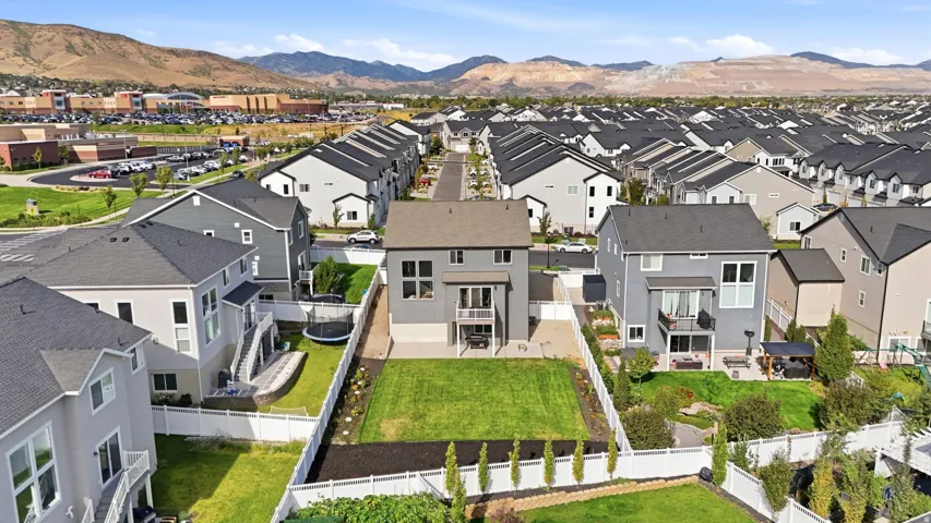 Modern residential community featuring multiple homes with dark roofing and light-toned siding