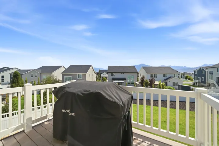 Exterior deck with wood-finish flooring and white railing