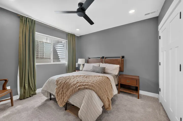 Recessed ceiling lighting, gray wall paint, carpeting, and a ceiling fan with integrated light