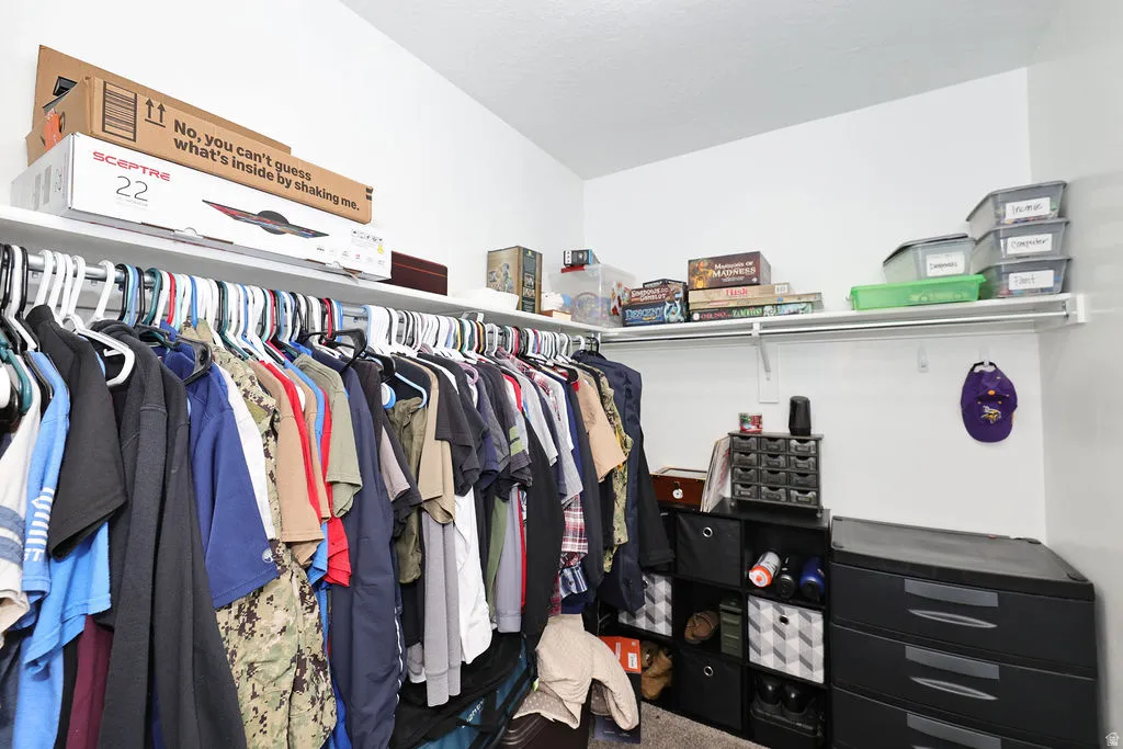 Corner closet with white walls and built-in shelving