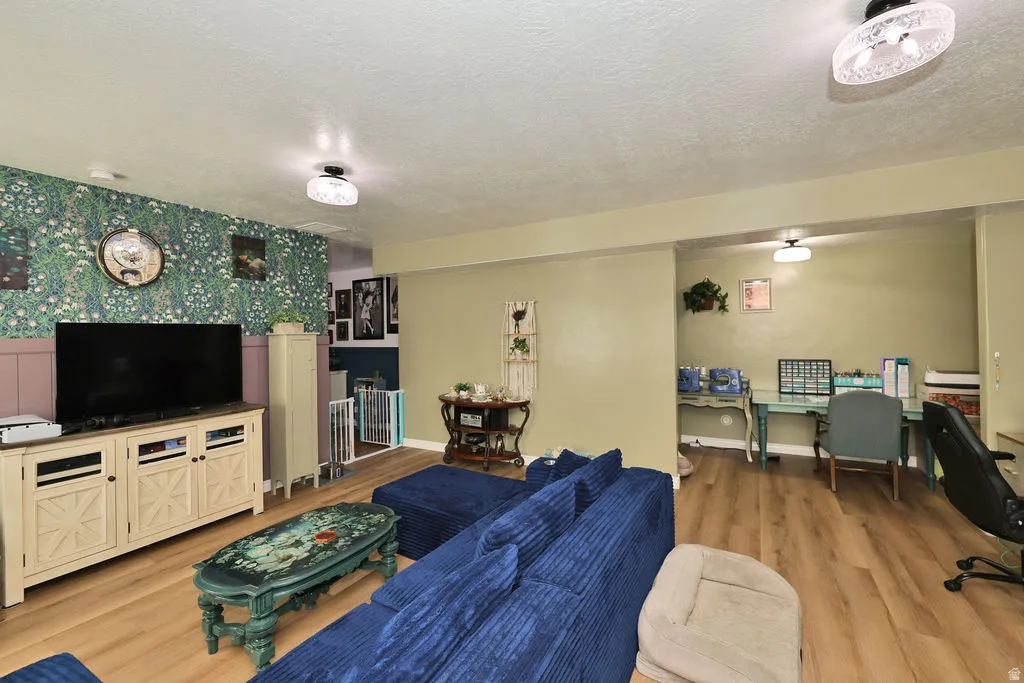 Wood-finish flooring throughout, with a dedicated work area and decorative wall treatments