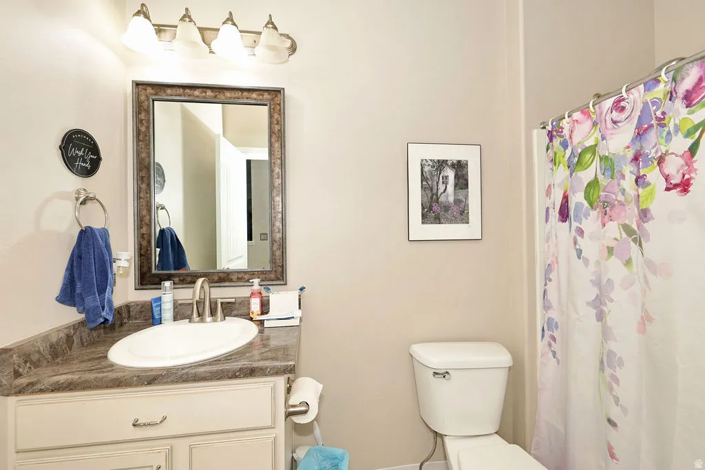 Vanity with an oval undermount sink, brushed nickel faucet, and a framed mirror