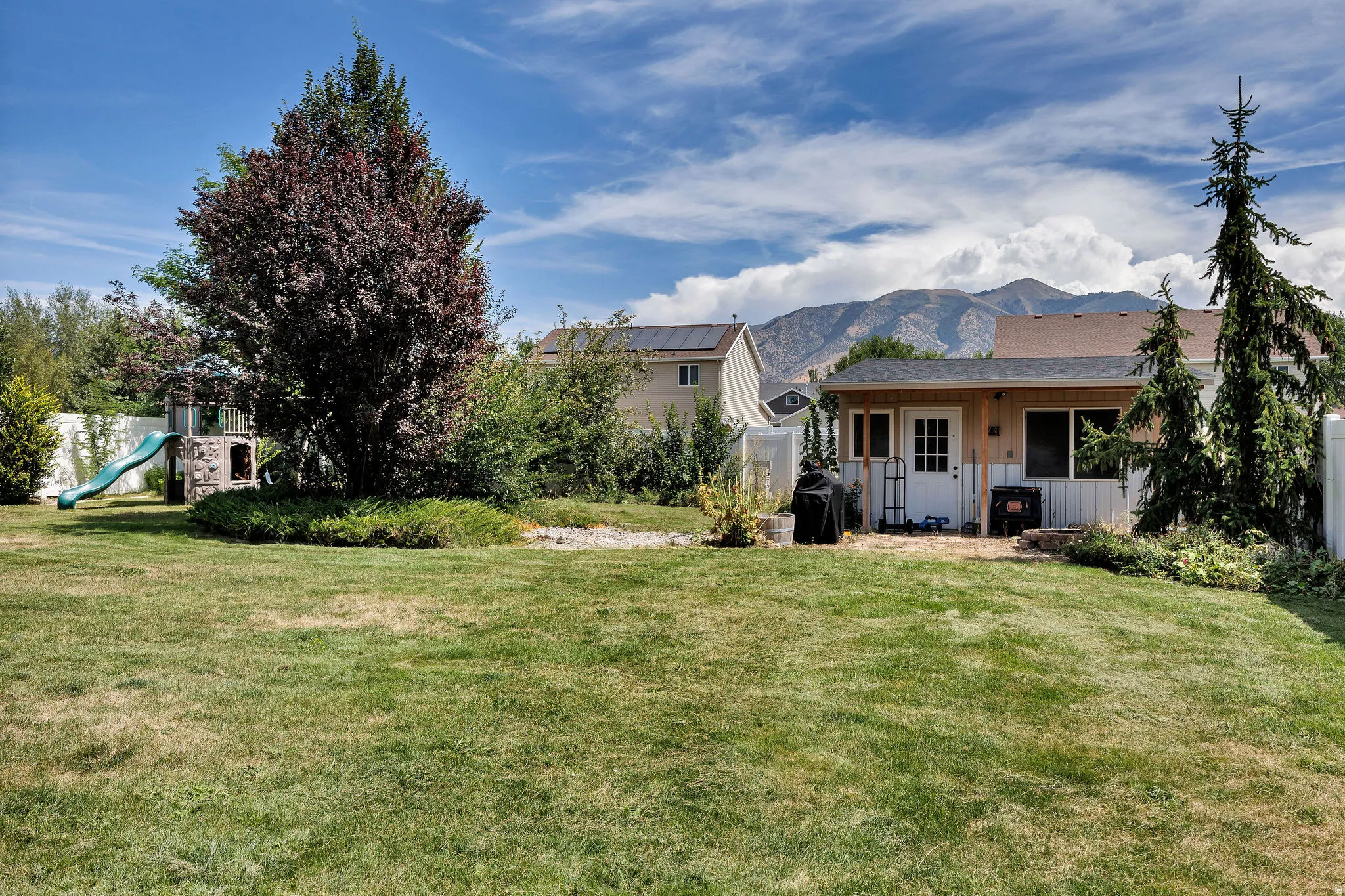 Expansive grassy lawn with mountain backdrop
