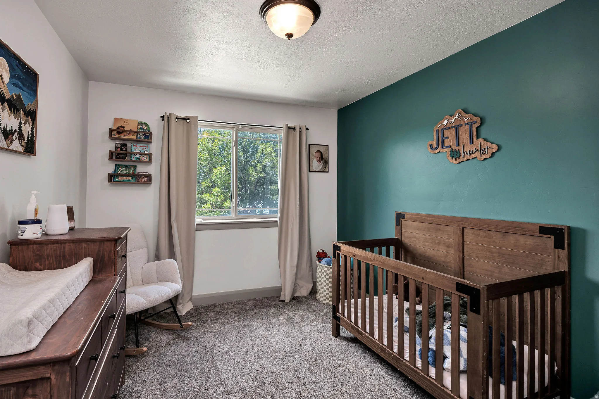 Window with natural light, wall-to-wall carpeting, and a built-in overhead light fixture