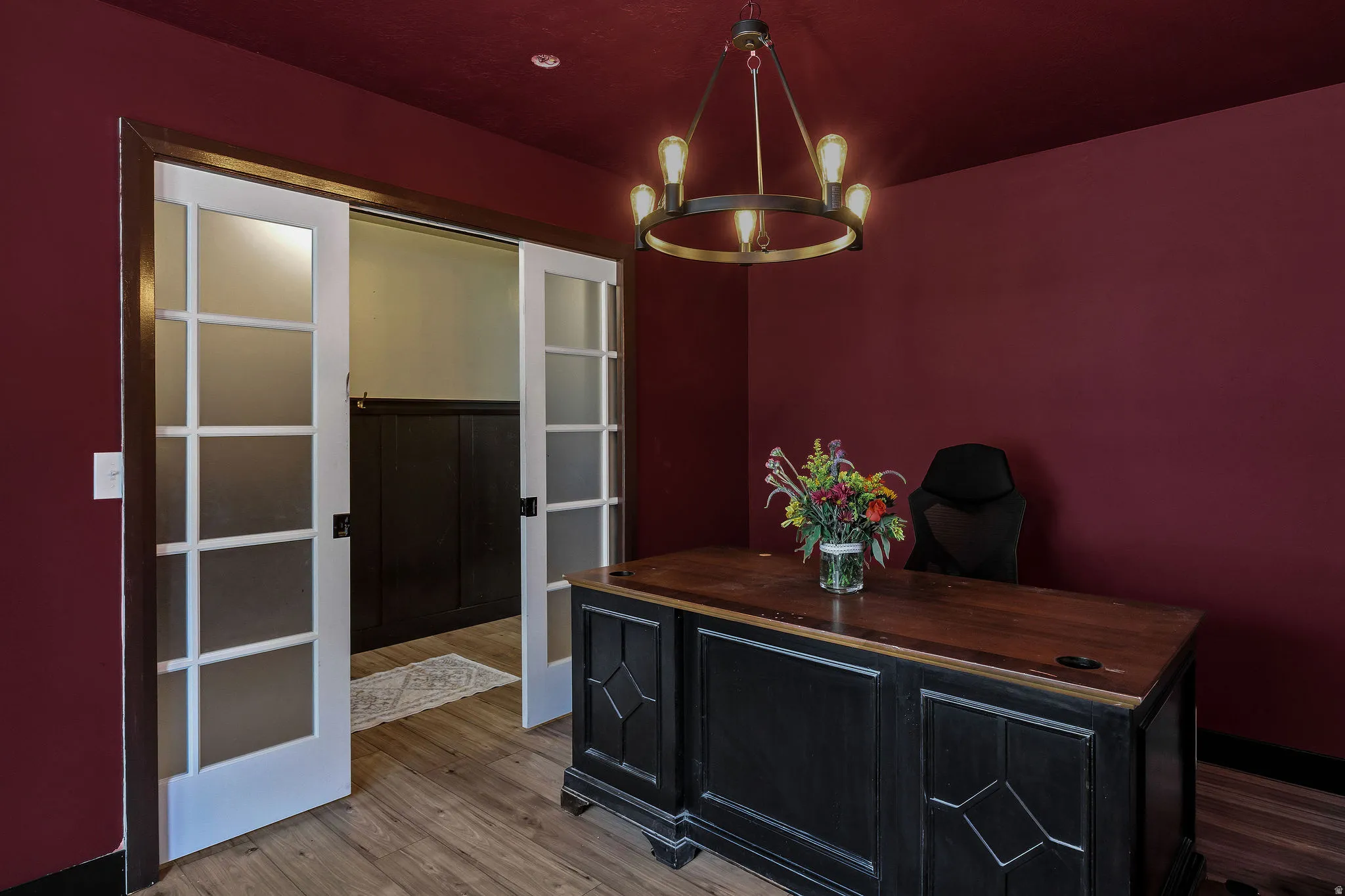 Wood-finish flooring, recessed lighting, and a chandelier with exposed bulbs