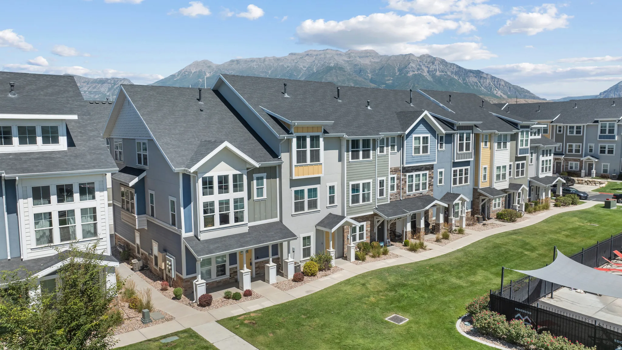 Modern multi-story townhomes with varied exterior siding and stone accents