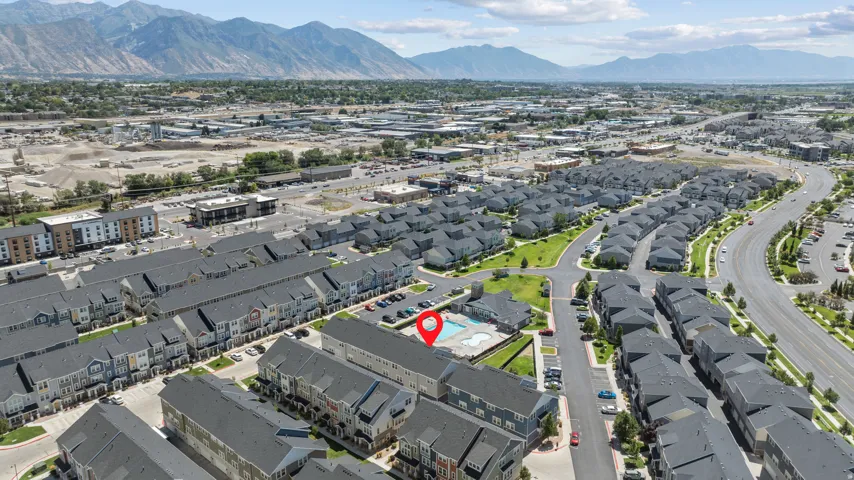 Community amenities featuring an outdoor swimming pool, paved roadways, and mountain scenery