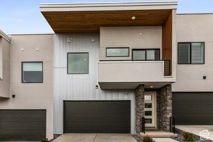 Modern exterior with stucco and corrugated metal paneling