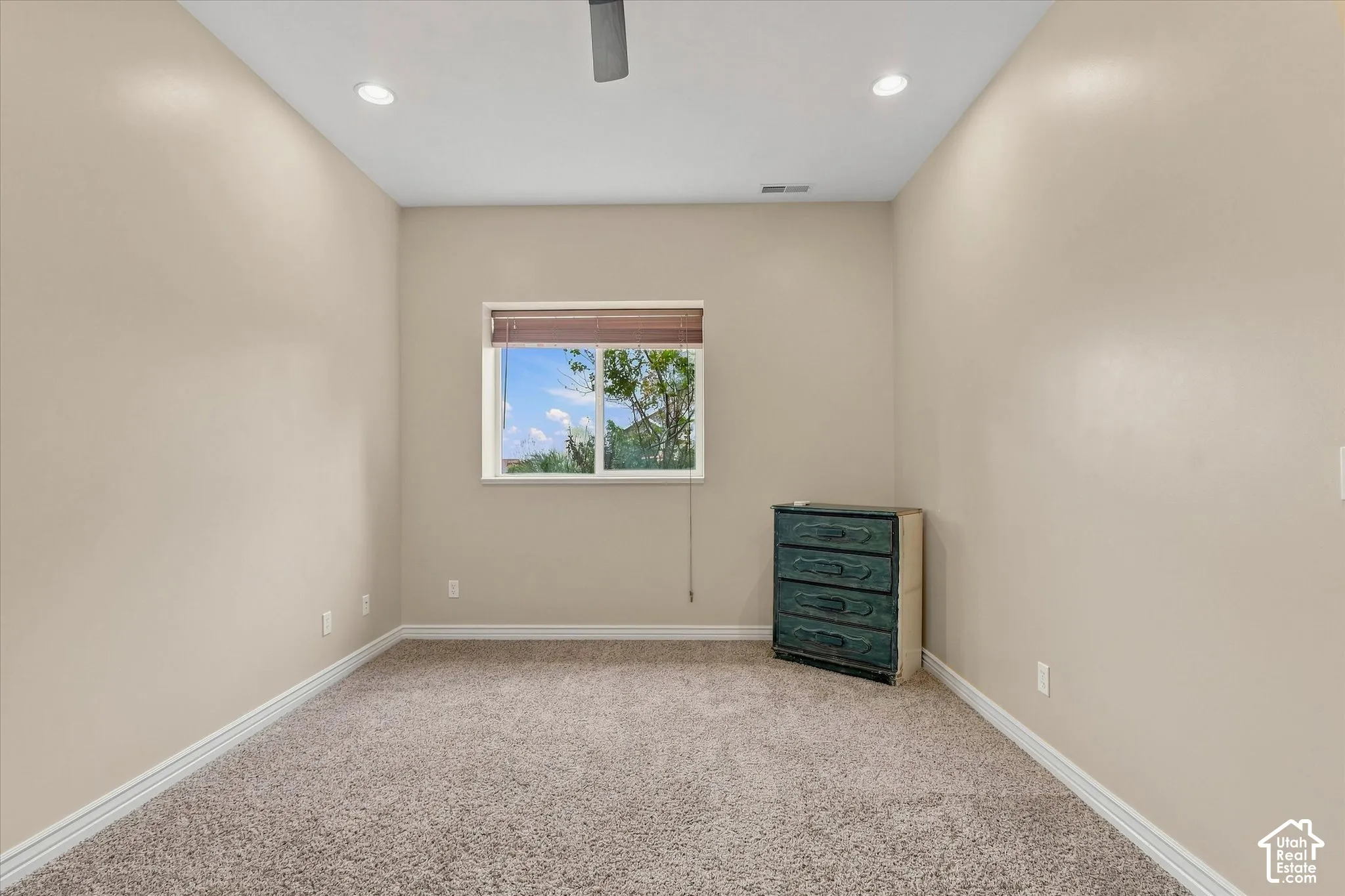 Recessed lighting, ceiling fan, window with wood-look blinds, light neutral wall color, and carpeted flooring