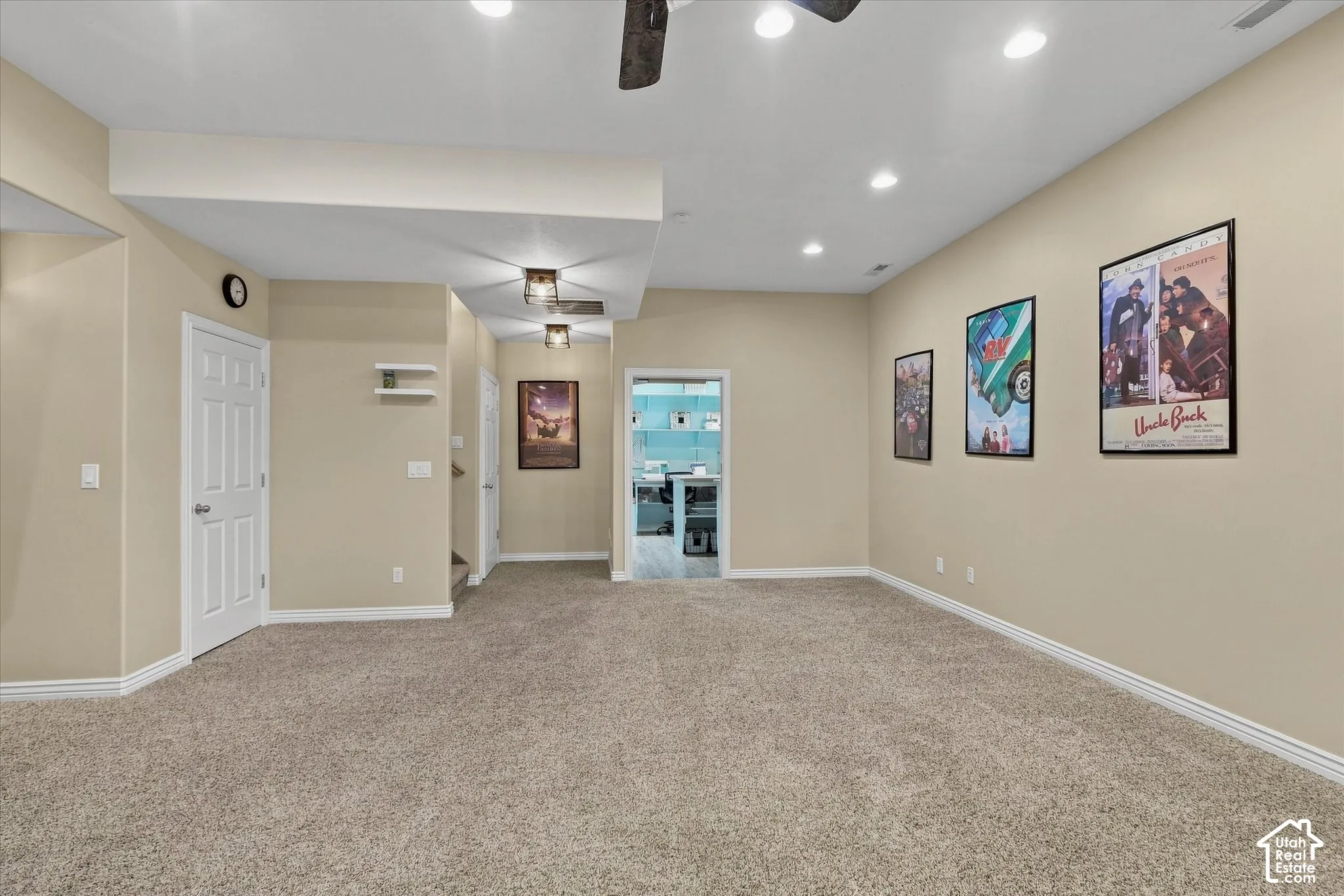 Carpeted floor, recessed ceiling lights, flush mount ceiling lights, white trim, and a white paneled door