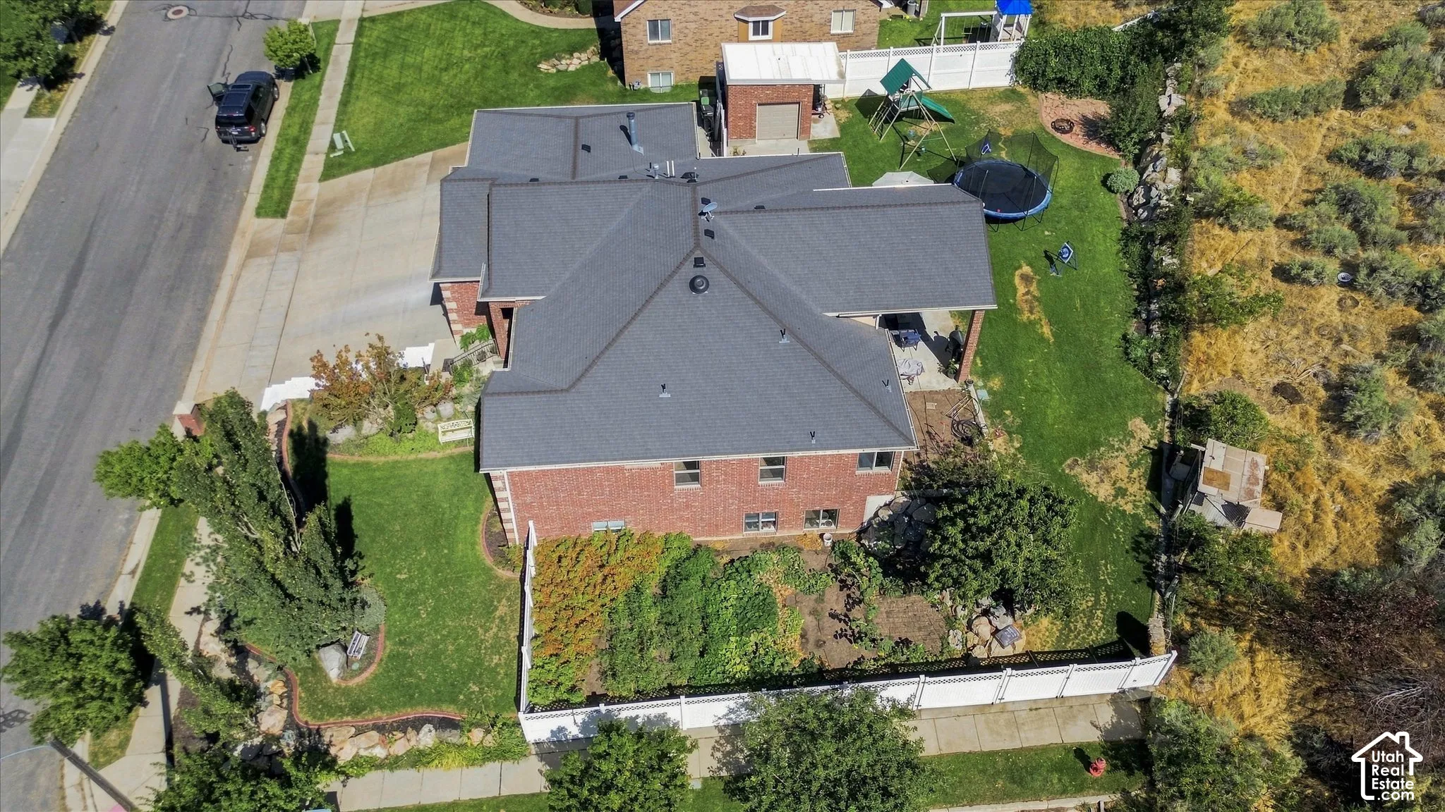 Brick exterior with a dark shingle roof and a covered patio