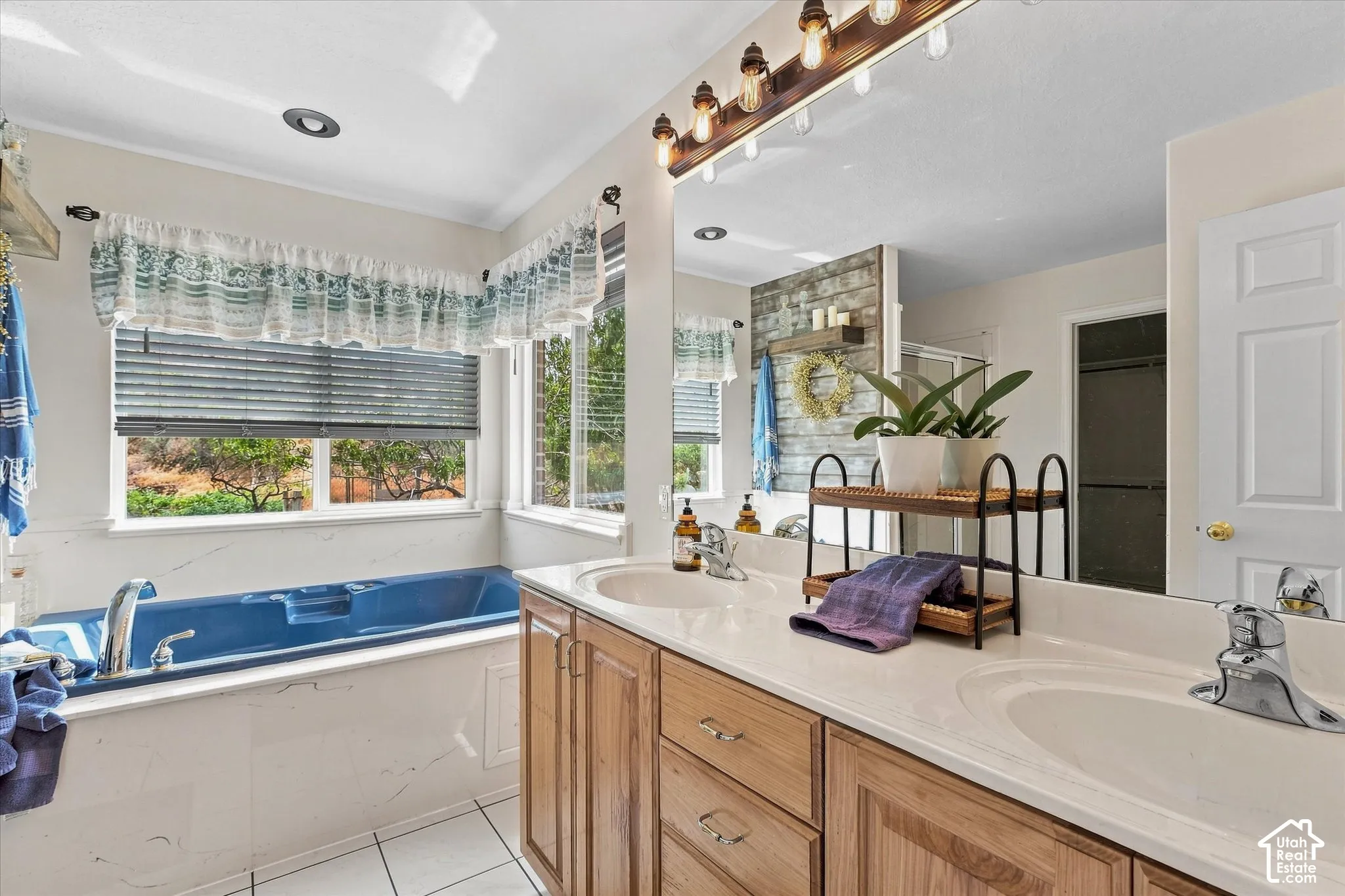 Dual vanity with integrated sinks, wood-finish cabinetry, and a full-width mirror