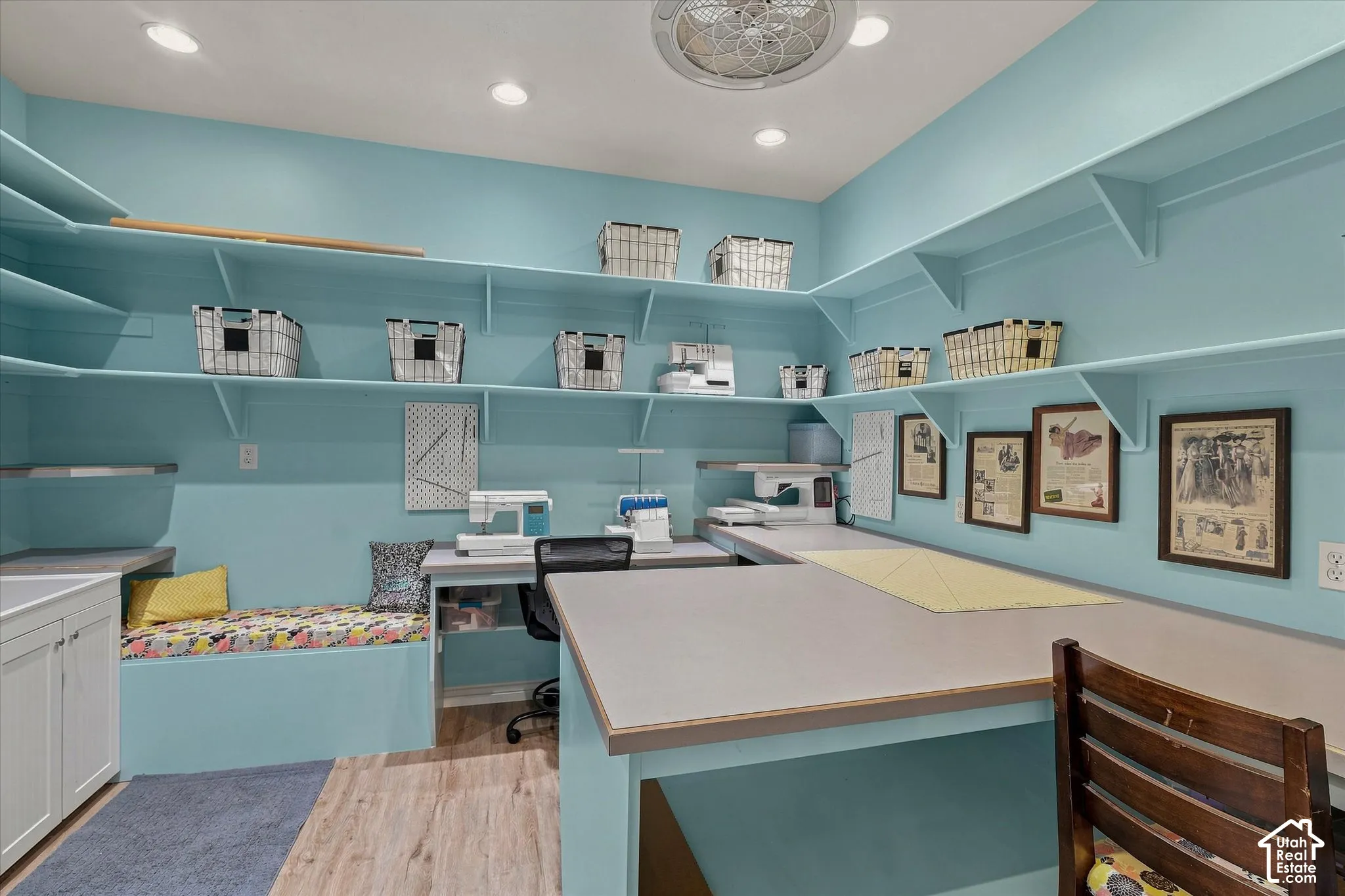 Built-in shelving, extensive countertop workspace, recessed lighting, ceiling fan, and wood-finish flooring