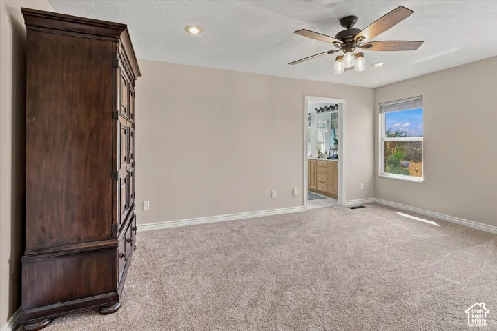 Neutral-toned walls complement plush carpeting