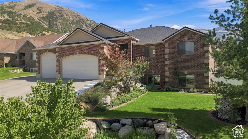 Brick exterior with light-toned trim accents, multi-pane windows, and an attached two-car garage