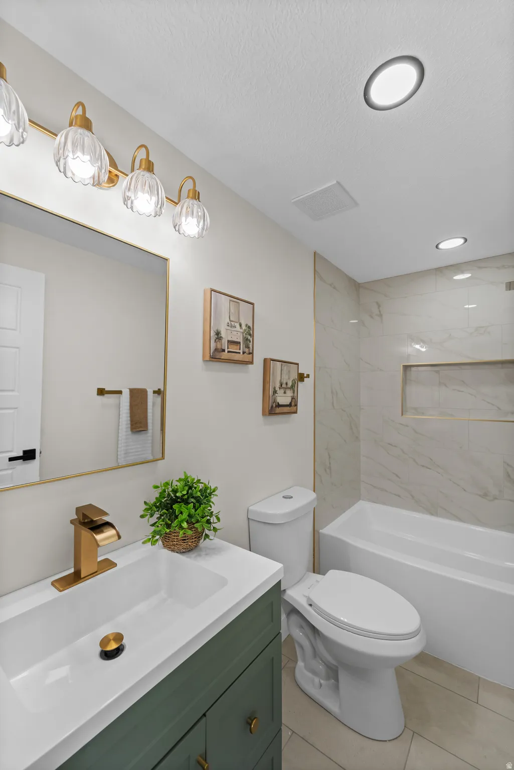 White porcelain tub with a tiled surround featuring a built-in niche