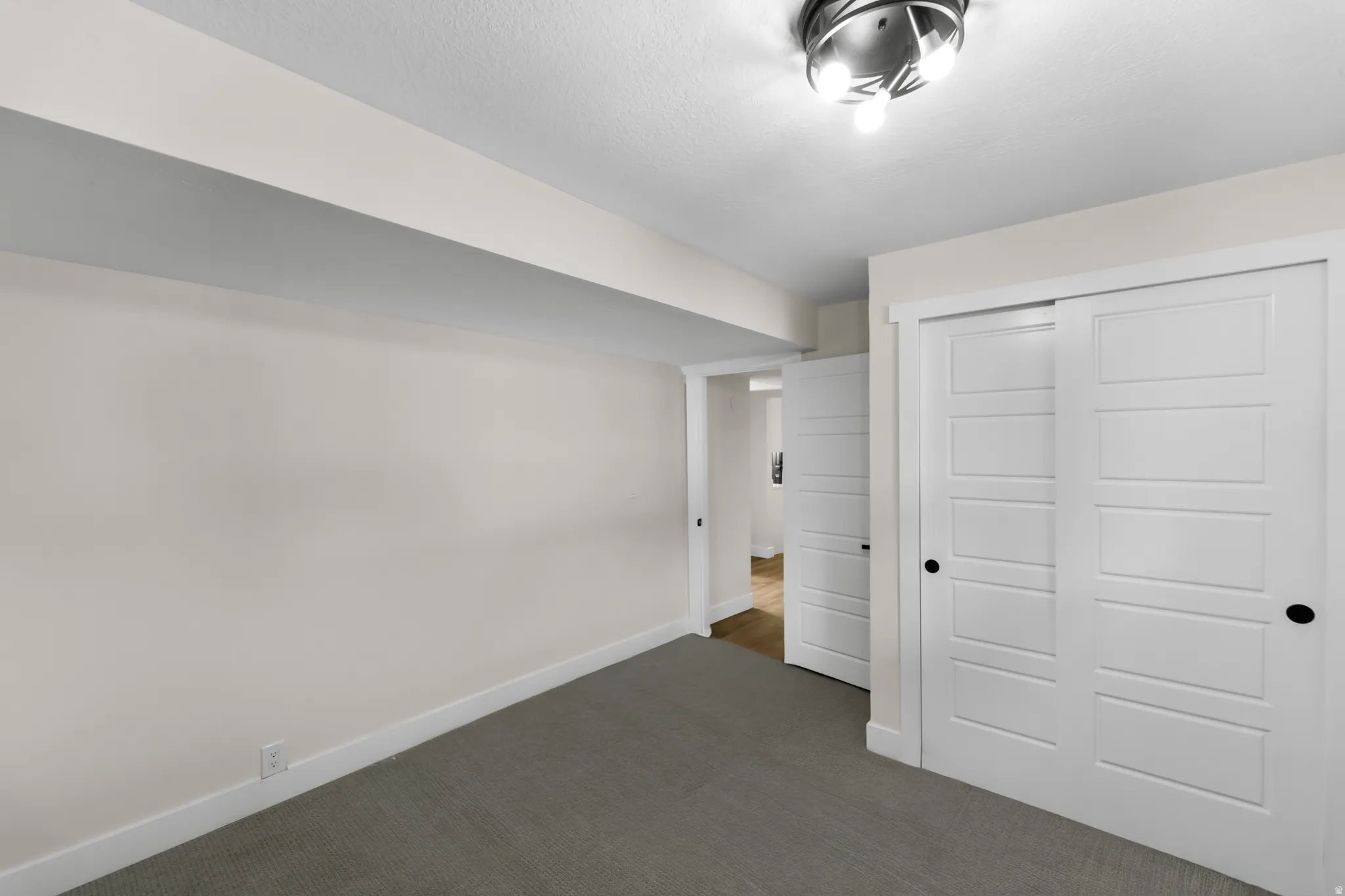 Neutral-toned carpeting with white walls and trim