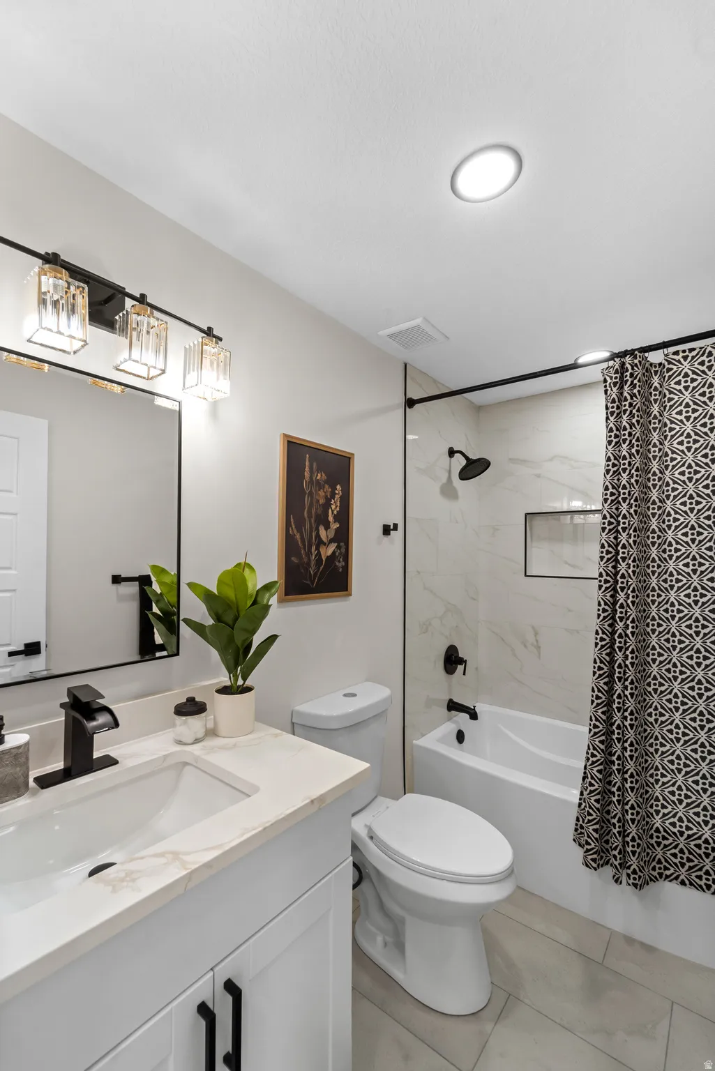 White vanity with quartz-finish countertop and undermount sink