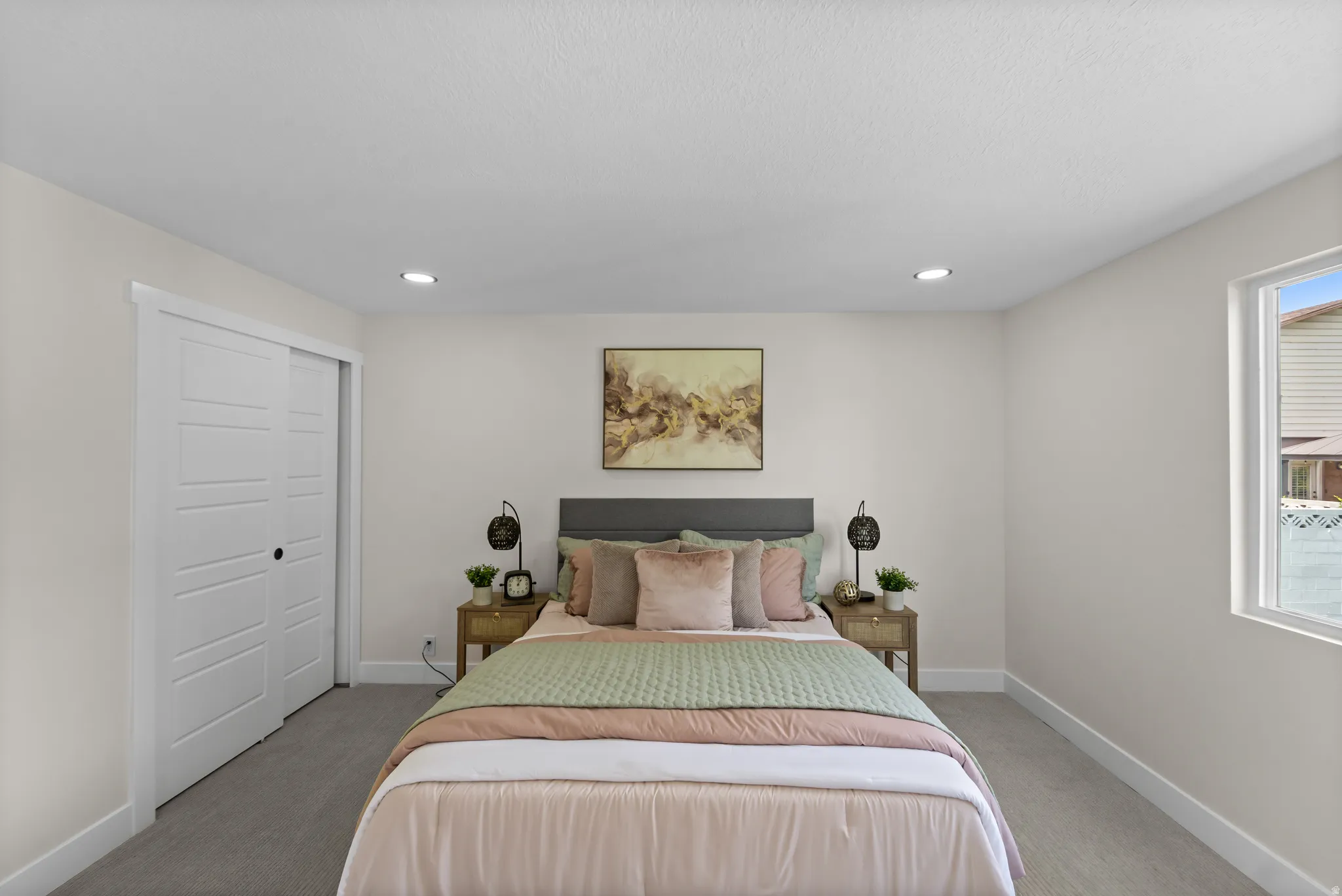 Recessed lighting, carpet flooring, sliding panel closet doors, and an exterior window
