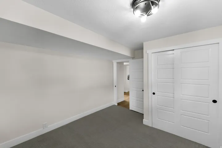 Neutral-toned carpeting with white walls and trim