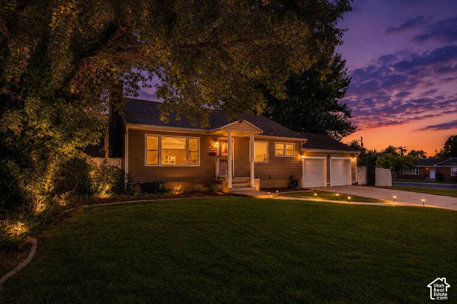 Traditional-style residence with siding exterior, multi-pane windows, and a two-car garage