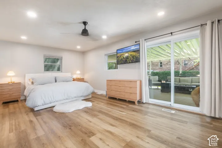 Recessed lighting, ceiling fan, wood-finish flooring, sliding glass doors to outdoor patio, and multiple windows
