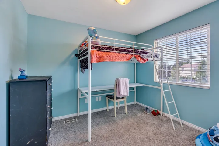 Recessed window with blinds, carpeted flooring, and a ceiling-mounted light fixture