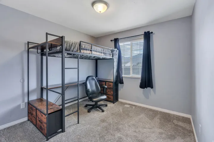 Carpeted flooring, window with blinds, and ceiling-mounted light fixture