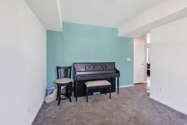 Wall-to-wall carpeting and a distinct accent wall create visual interest