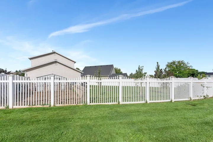 Manicured lawn with white picket fencing