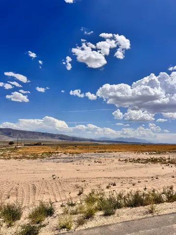 Expansive land parcel featuring desert landscaping and distant mountain ranges