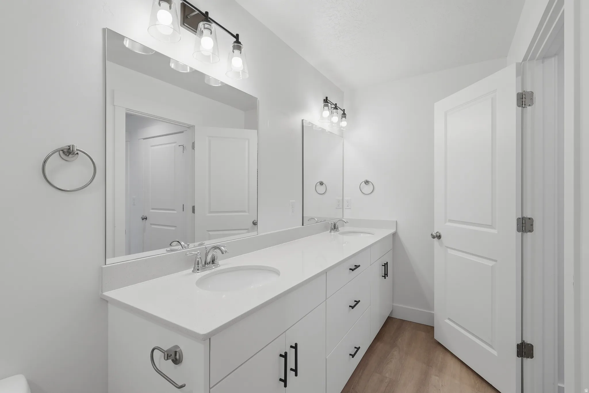 Dual vanity with white cabinetry and integrated sinks