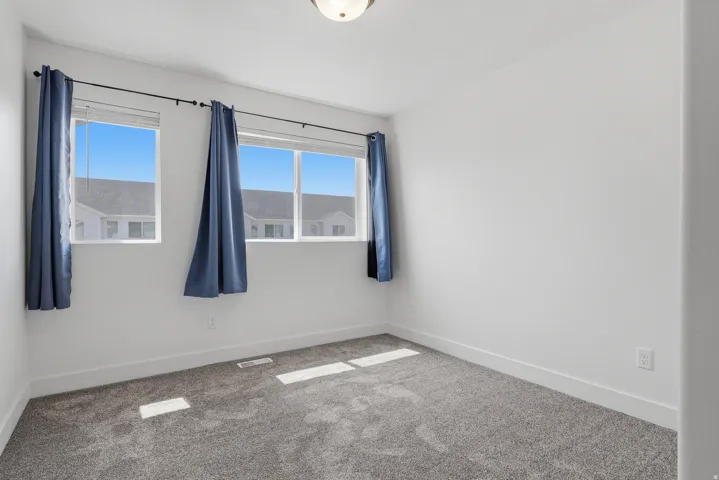 Neutral wall finishes, plush carpeting, and multiple windows