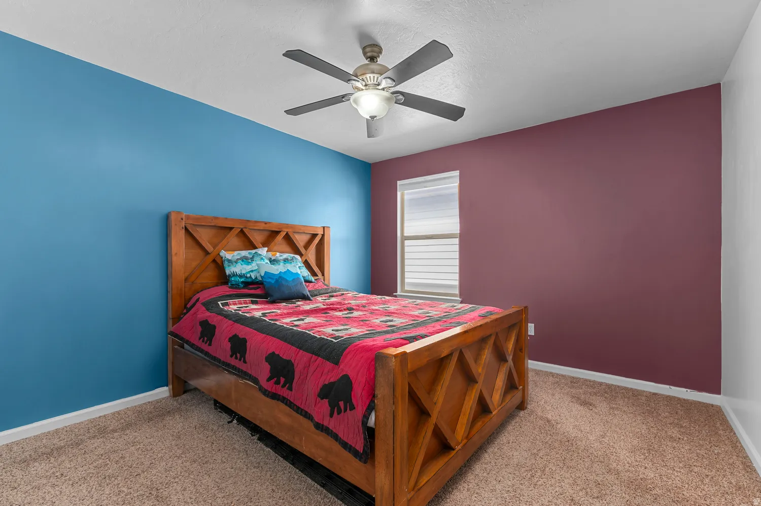 Bedroom featuring neutral carpet flooring, a window with blinds, and a ceiling fan with integrated lighting