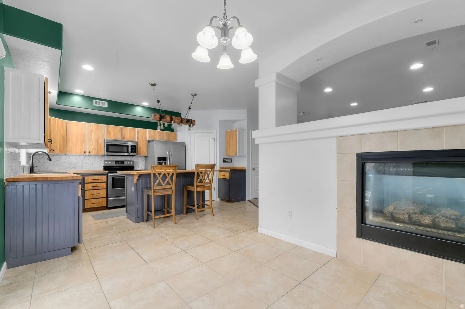 Open concept living space featuring tile flooring and a built-in fireplace