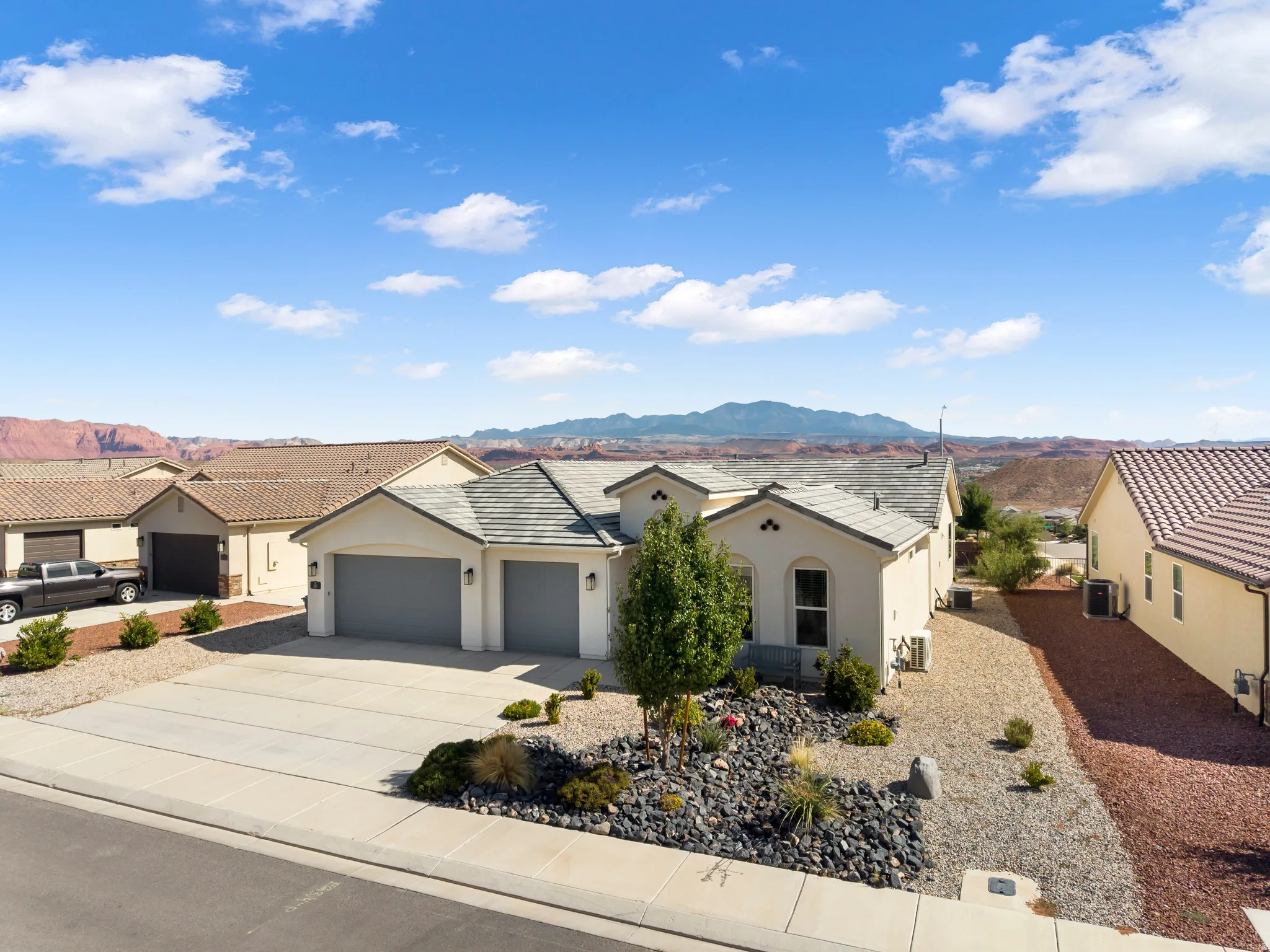 Neutral-toned stucco exterior with a gray tile roof