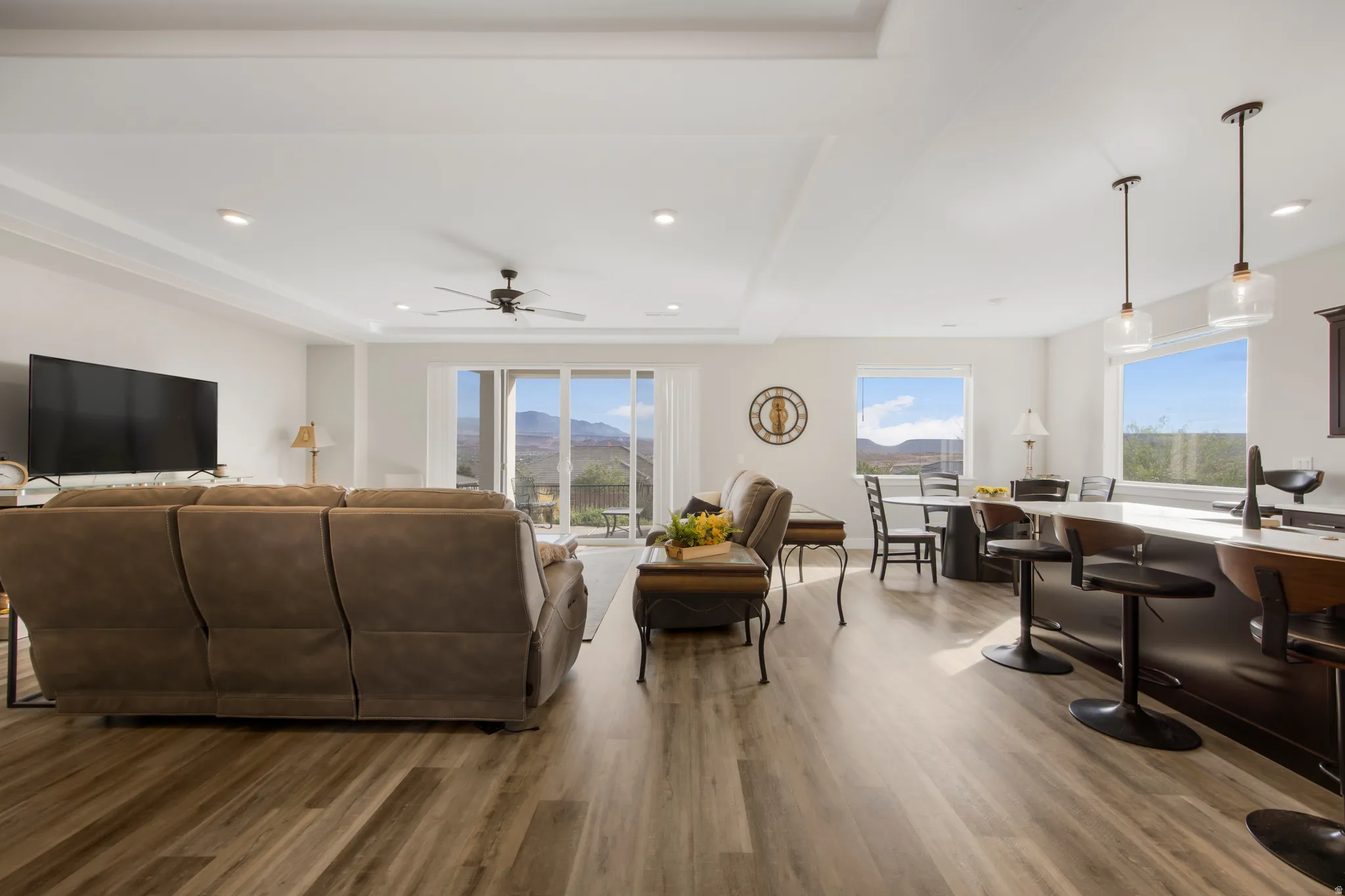 Open-concept living area featuring wood-finish flooring, recessed lighting, and a ceiling fan