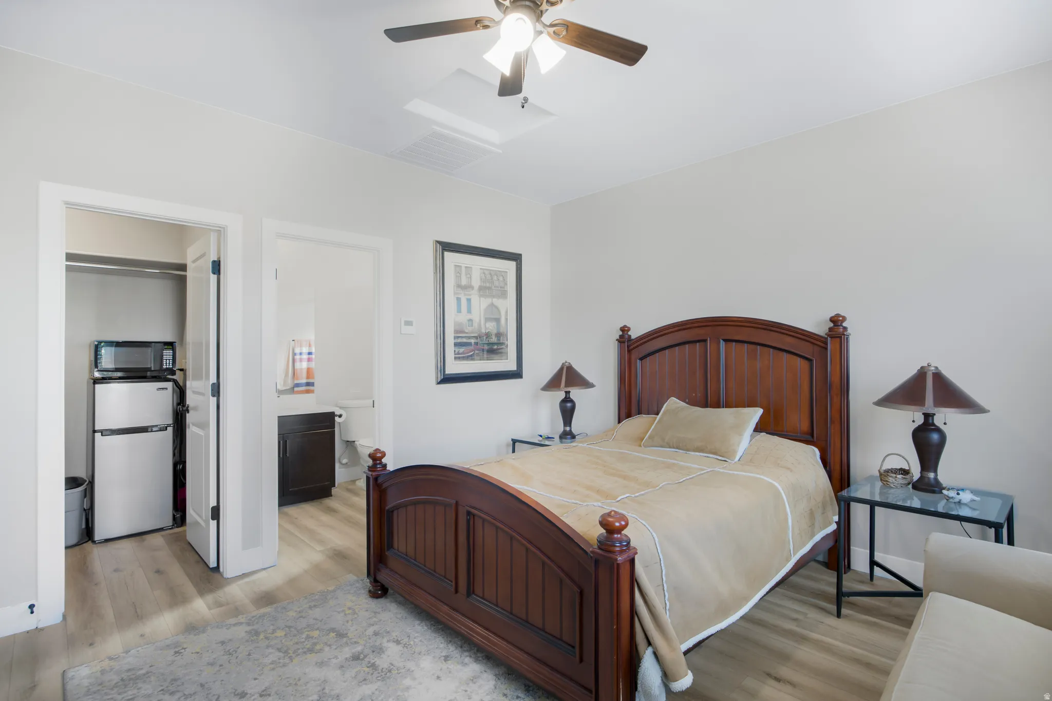 Wood-finish flooring, ceiling fan, and built-in closet with appliances