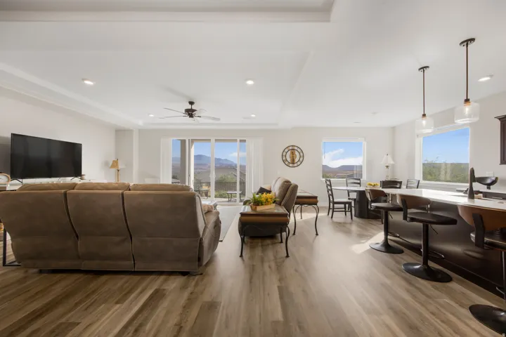 Open-concept living area featuring wood-finish flooring, recessed lighting, and a ceiling fan