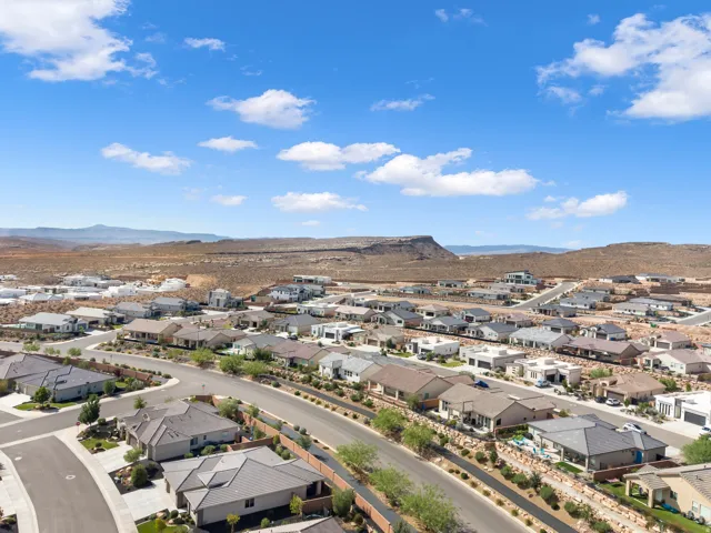 Residential neighborhood with varied architectural styles situated against a desert landscape