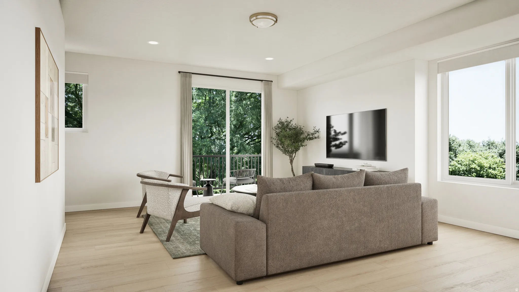 Spacious living area featuring wood-finish flooring, ample natural light, recessed ceiling lighting, and a sliding glass door leading to an outdoor balcony