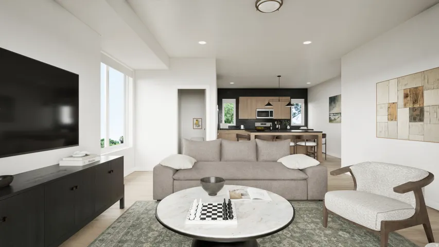 Expansive living area featuring light wood-finish flooring, recessed lighting, and a large window