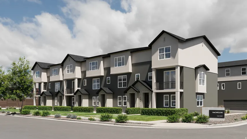 Modern townhome exteriors featuring multiple window styles, contemporary siding, and a landscaped frontage with green shrubs