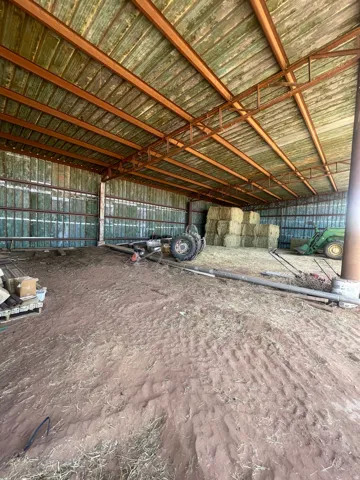 Large open-span structure with a corrugated metal roof and exposed support beams