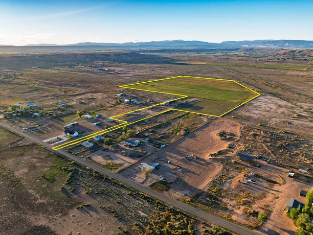 Expansive land parcel featuring open fields and established roads