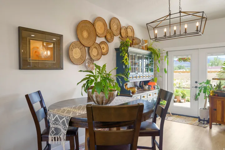 Wood-finish flooring, built-in display cabinet, and double French doors opening to the exterior