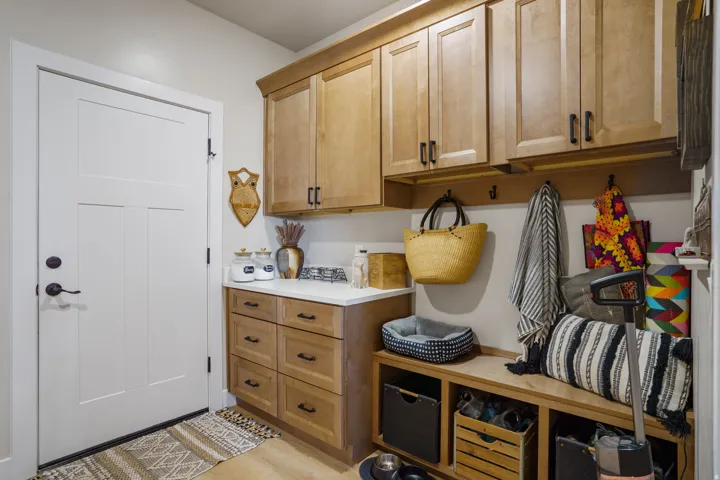 Built-in cabinetry with wood-finish doors and black hardware