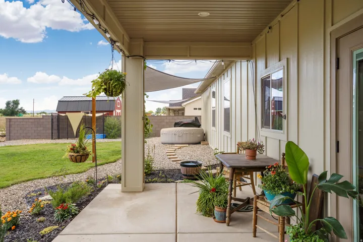 Patio with concrete flooring, overhead lighting, and board and batten siding