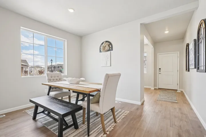 Bright interior with recessed lighting, wood-finish flooring, and a window with white grid panes